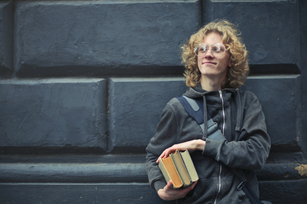 male student holding books